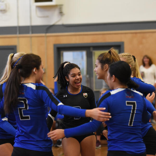 Senior girls volleyball team in a huddle