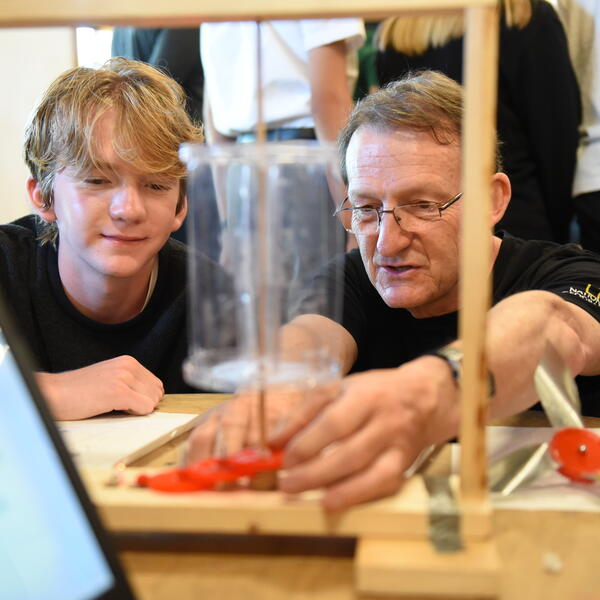 Senior School student closely watching a teacher's demonstration