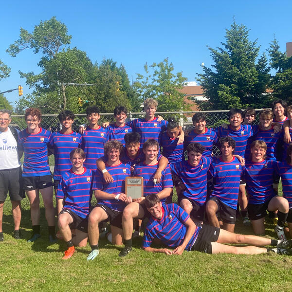 Senior Boys Rugby team pose with their trophy