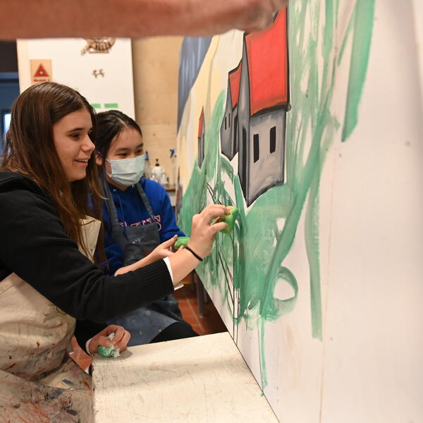 Students painting in art studio