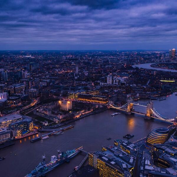 The skyline of London, England at twilight, taken over the Thames.