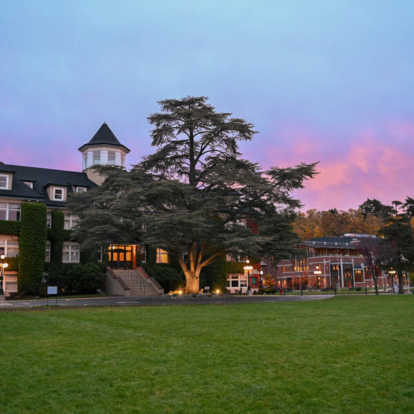 An early morning photo of the School House Building with a dark but colourful sky in the background. 