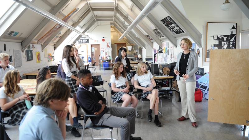 Teacher instructing a Senior School art class