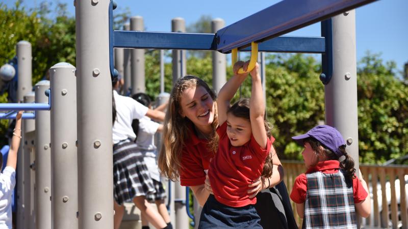 Lifer and kindergartener in the Junior School playground