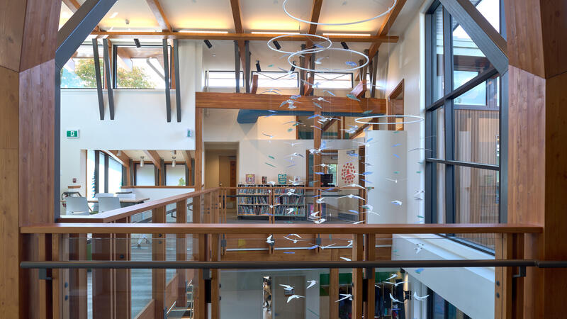An upstairs view of the new Junior School Annex highlighting lots of natural light, wood beams and windows and glass walls.