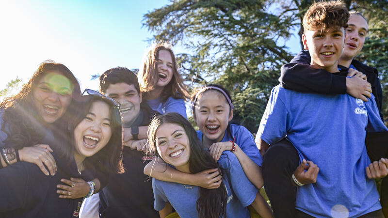 Coed group of campers smiling wearing smus camps t-shirts