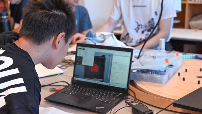 Camper in Engineering Camp working on laptop