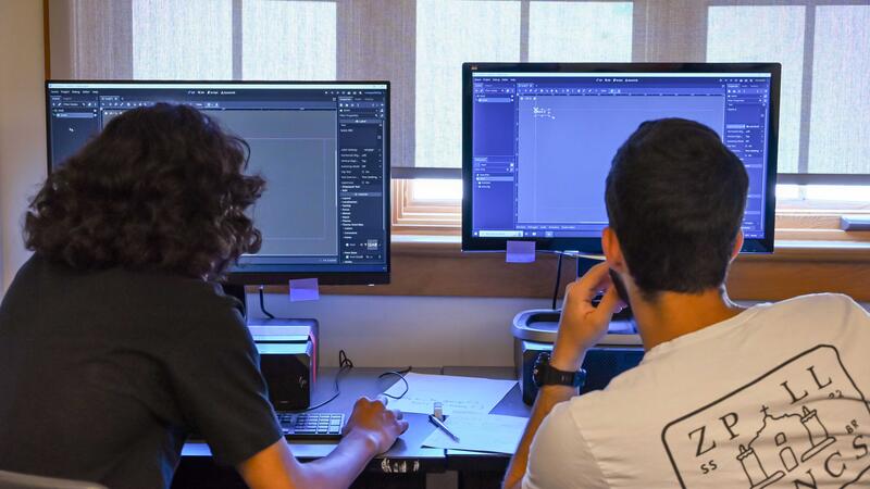Two Game Development Campers working on their projects in Godot engine