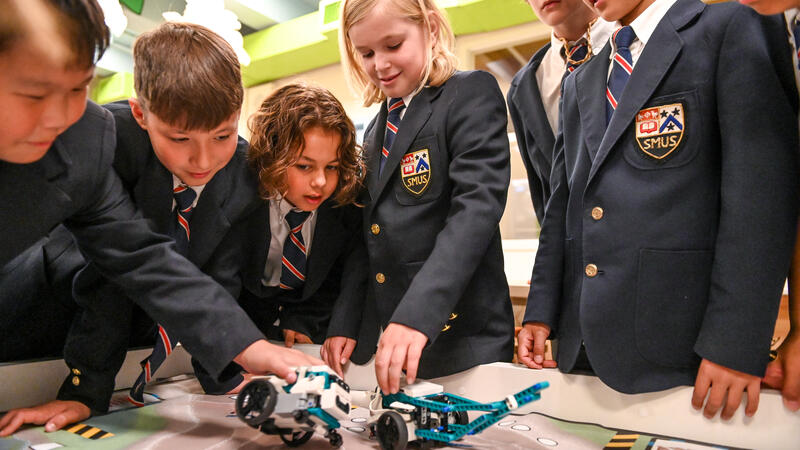 Junior School Grade 5 students play with lego robots in the iLab