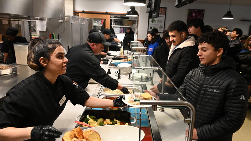SAGE Dining staff serve food in Graves Hall