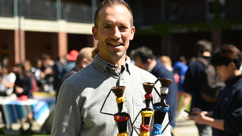 Regan Daly poses with handmade dolls for sale in support of Hope for Youth Uganda