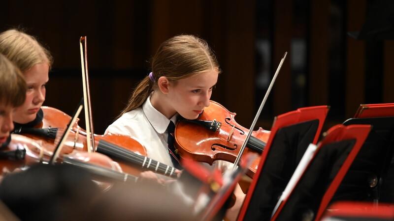 Middle School Strings Violinist performs during concert