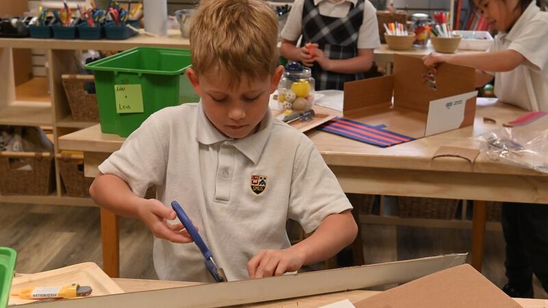 Grade 2 student uses scissors and cardboard in the iLab