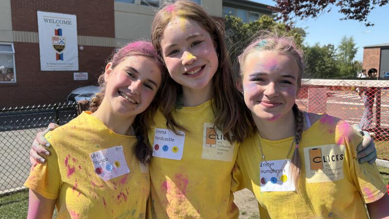 Middle Clicks and Consequences Conference attendees covered in colour powder