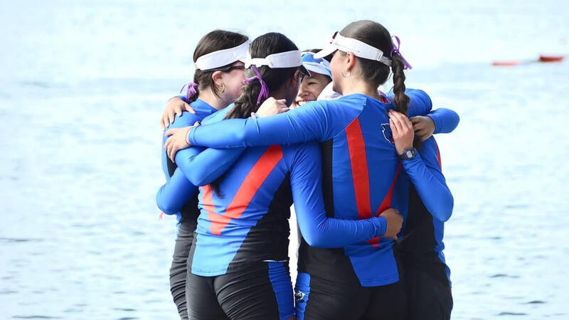 Rowing teammates huddle up after a big win