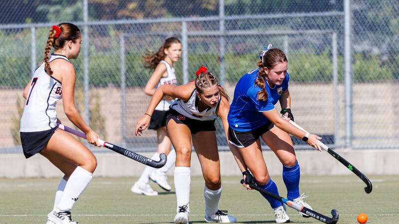 Mackenna Brown dribbles the field hockey ball in competition at the Friendship Cup