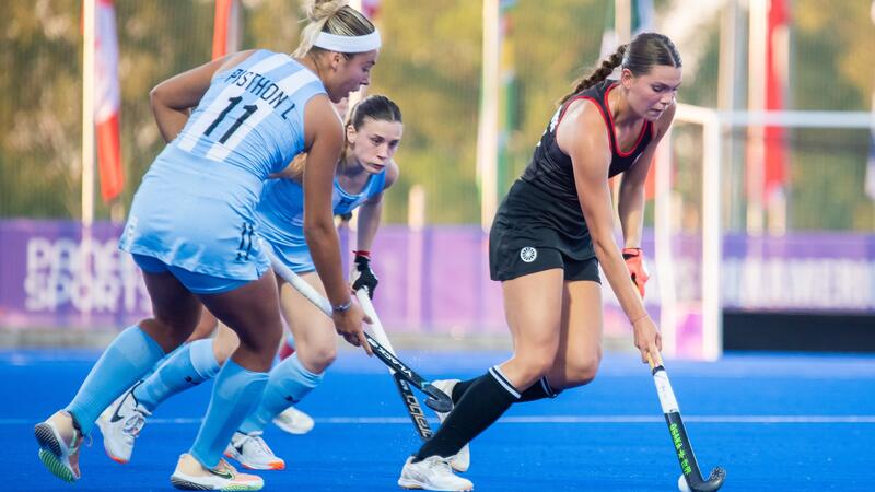 Wynn Brown '23 dribbles the ball in a field hockey game for team Canada