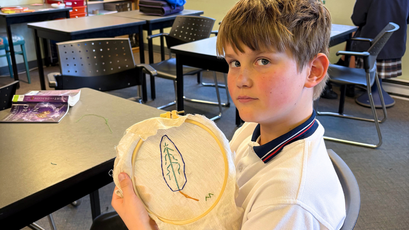 A student doing embroidery stitching