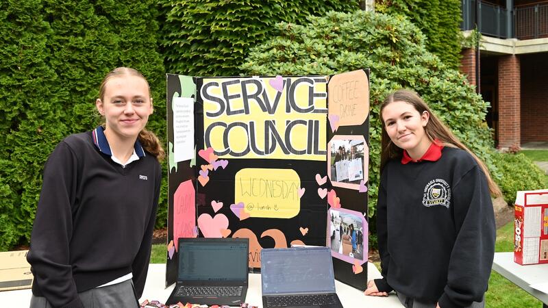 Service Council heads Lucy Turnbull and Bianca Batoni pose with their service council sign and table