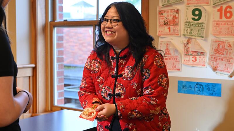 Jennifer Mao hands out a lucky red envelope 