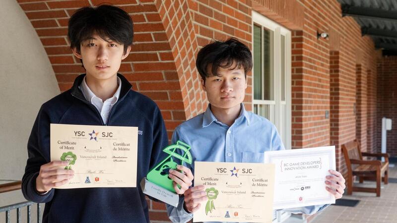 Alvin Tsao and Rubio Wu pose outsdie with their science fair certificates.