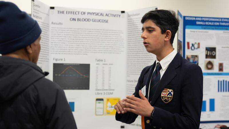 Shaan Arneja explains his science fair project to a judge.