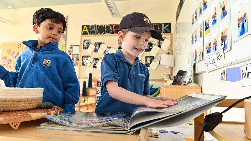 Junior Kindergarten students read a book