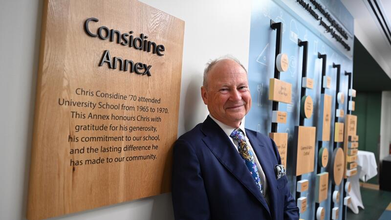 Chris Considine '70 with the Considine Annex plaque
