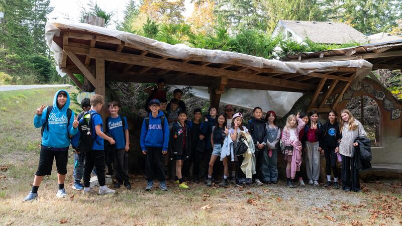 Group photo of Middle School students under a man-made awning.