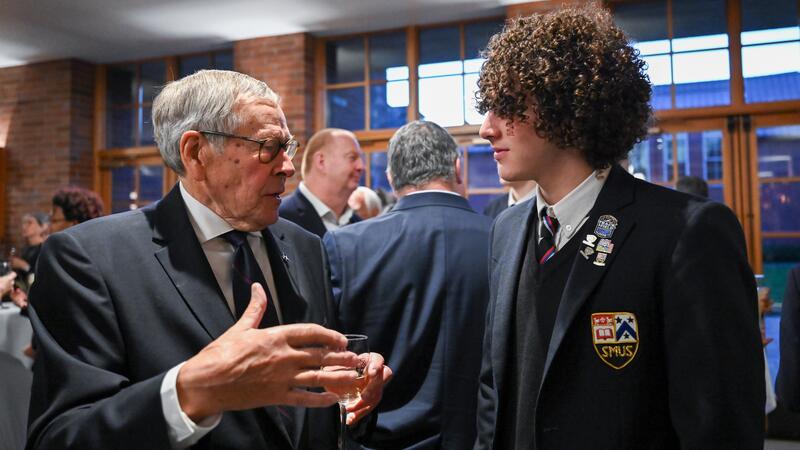 SMUS alumni and students have an engaging conversation during a reception.