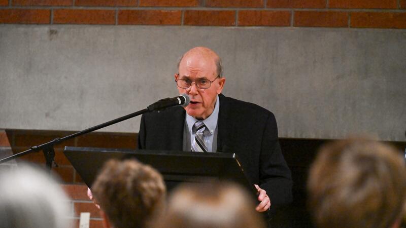 Tom Rigos delivers a keynote address at the podium